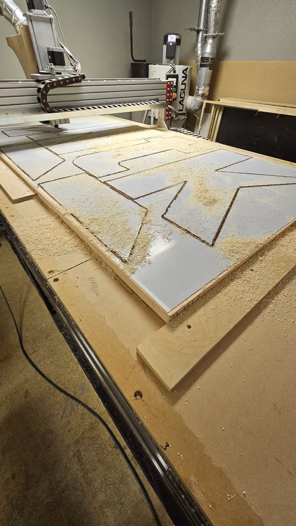 CNC router cutting cabinet parts from a sheet